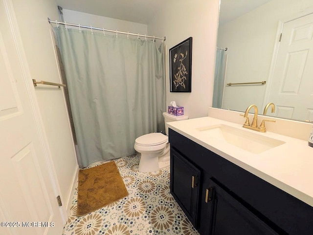 bathroom with vanity, toilet, and tile patterned floors