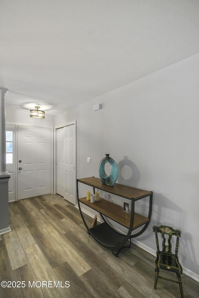 entrance foyer with wood-type flooring and decorative columns