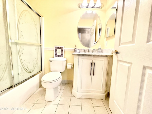 full bathroom featuring tile patterned flooring, vanity, bath / shower combo with glass door, and toilet