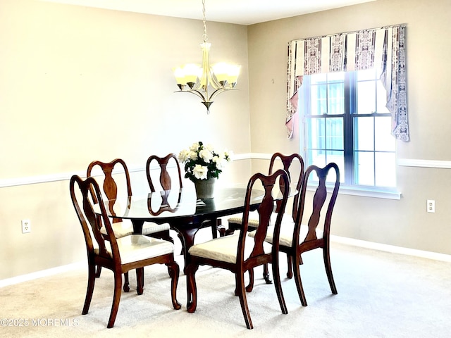 carpeted dining area with an inviting chandelier