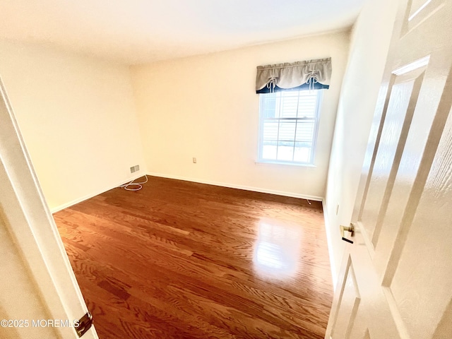 unfurnished room featuring hardwood / wood-style flooring