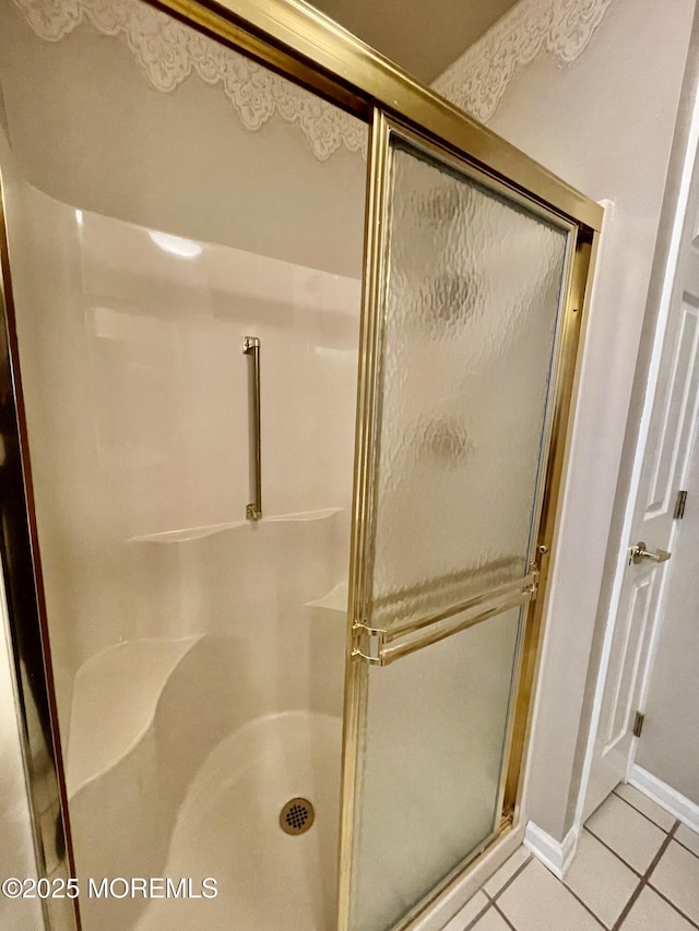 bathroom with tile patterned floors and walk in shower