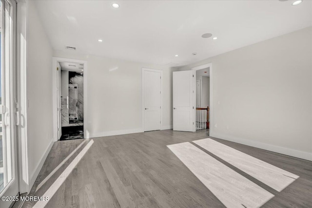 unfurnished bedroom with wood-type flooring