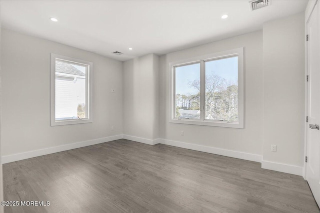 empty room with dark hardwood / wood-style flooring