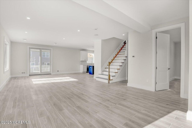 unfurnished living room with light hardwood / wood-style flooring