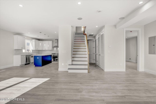 unfurnished living room featuring sink and electric panel