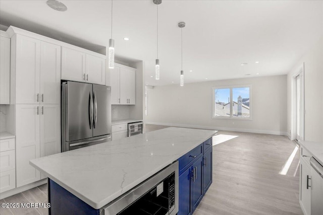 kitchen with white cabinetry, wine cooler, stainless steel refrigerator, and blue cabinets