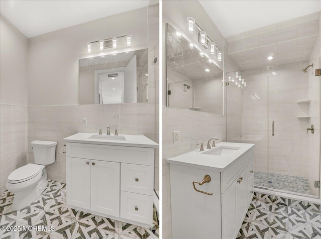 bathroom with tile walls, vanity, tile patterned floors, and a shower with door