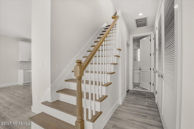 staircase with wood-type flooring