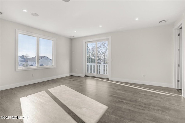 spare room featuring dark hardwood / wood-style flooring