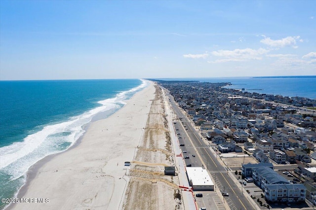 aerial view with a water view and a beach view