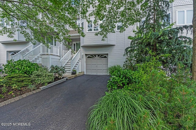 105 Geranium Ct, Toms River, NJ 08753 - view of front facade featuring stairway, a garage, and driveway