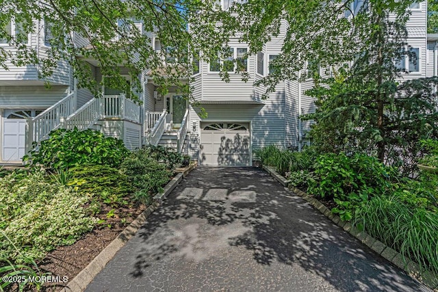 105 Geranium Ct, Toms River, NJ 08753 - view of front of house featuring stairs, an attached garage, and asphalt driveway