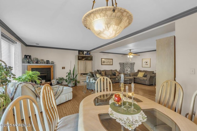 105 Geranium Ct, Toms River, NJ 08753 - dining space featuring wood finished floors, a ceiling fan, crown molding, and a fireplace