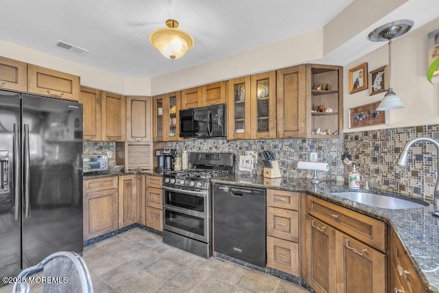 105 Geranium Ct, Toms River, NJ 08753 - kitchen with black appliances, brown cabinets, and decorative backsplash