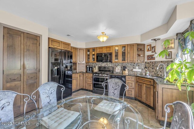 105 Geranium Ct, Toms River, NJ 08753 - kitchen with black appliances, brown cabinetry, tasteful backsplash, and glass insert cabinets