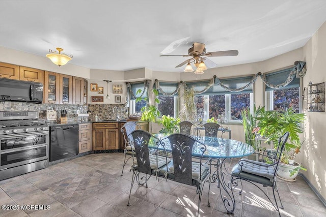 105 Geranium Ct, Toms River, NJ 08753 - kitchen with black appliances, brown cabinets, decorative backsplash, a ceiling fan, and dark countertops