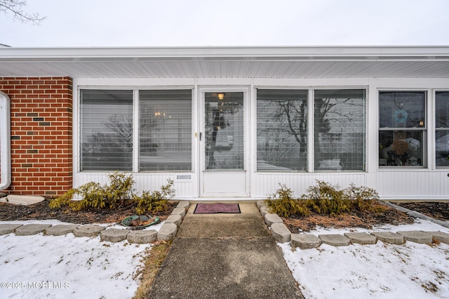 view of snow covered property entrance