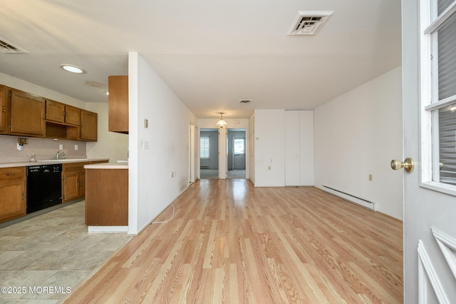 kitchen with a baseboard heating unit, backsplash, light hardwood / wood-style flooring, and dishwasher