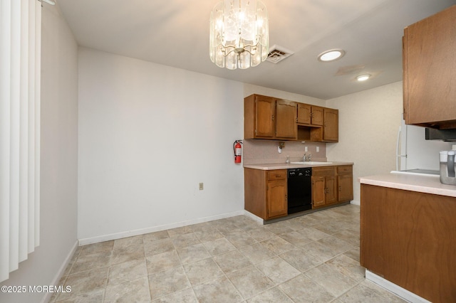 kitchen with tasteful backsplash, an inviting chandelier, hanging light fixtures, dishwasher, and white fridge