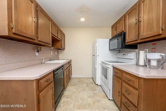 kitchen featuring sink, black appliances, and light tile patterned flooring