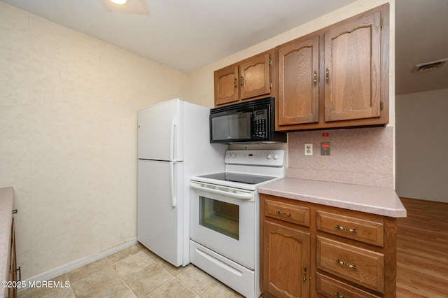 kitchen with backsplash and white appliances