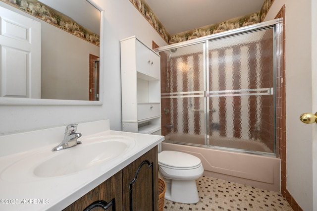 full bathroom with toilet, vanity, and shower / bath combination with glass door