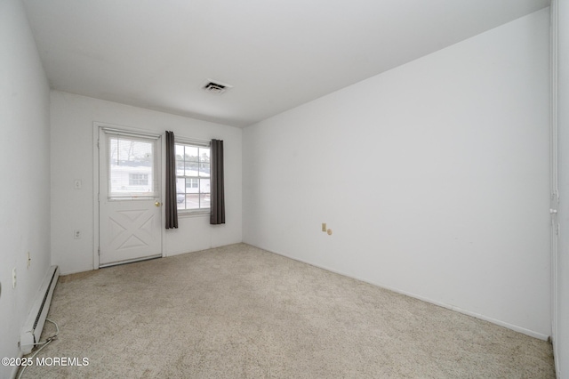 unfurnished room with a baseboard radiator and light carpet