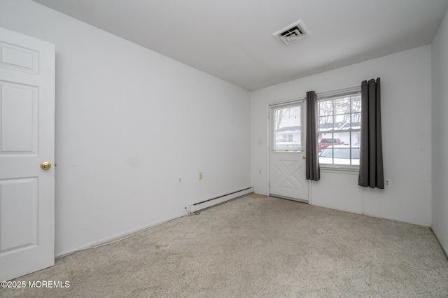 carpeted spare room with baseboard heating