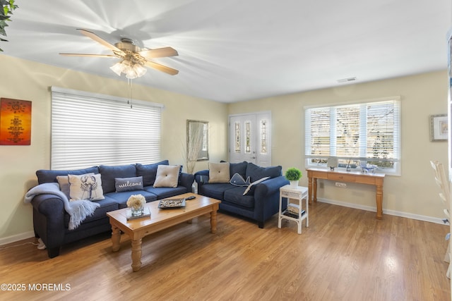 living room with ceiling fan and light wood-type flooring