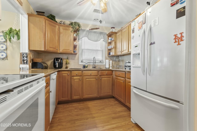 kitchen with sink, white appliances, ceiling fan, decorative backsplash, and light wood-type flooring