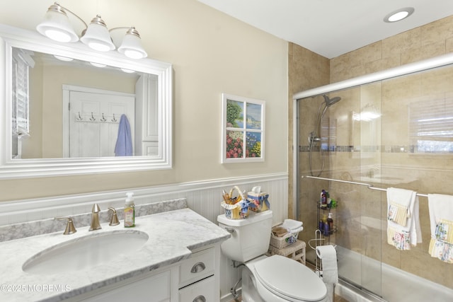 bathroom with vanity, an enclosed shower, and toilet