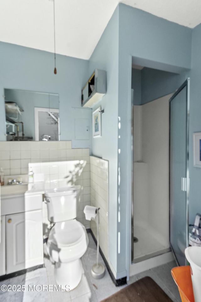 bathroom with tile patterned flooring, backsplash, vanity, and a shower with shower door