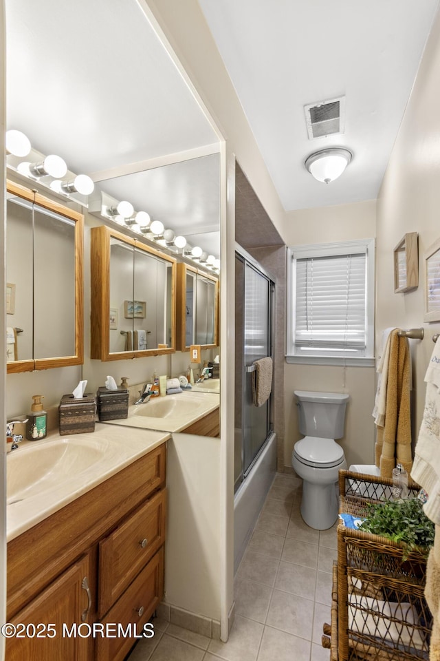 full bathroom with vanity, tile patterned floors, enclosed tub / shower combo, and toilet