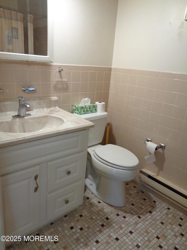 bathroom featuring tile patterned floors, toilet, tile walls, and vanity