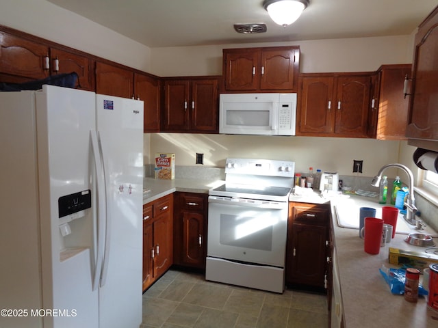 kitchen featuring sink and white appliances