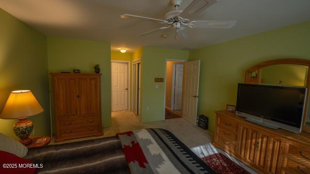 living room with carpet flooring and a ceiling fan