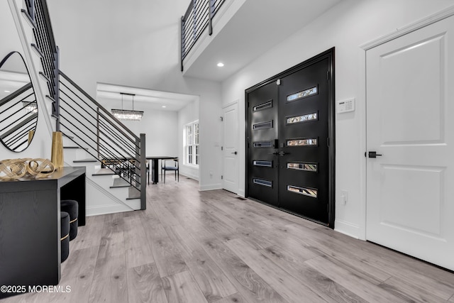 entryway featuring a notable chandelier and light hardwood / wood-style floors