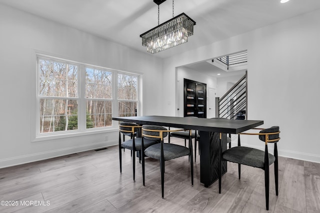 dining room with an inviting chandelier and wood-type flooring