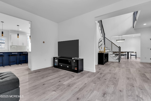 living room featuring an inviting chandelier and light wood-type flooring