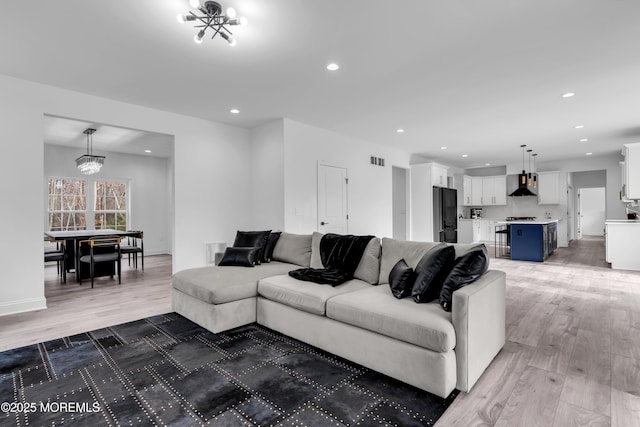 living room with hardwood / wood-style flooring and a chandelier