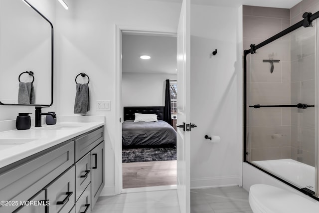 full bathroom with vanity, shower / bath combination with glass door, and toilet