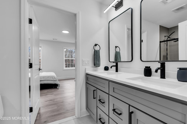 bathroom with vanity, hardwood / wood-style floors, and an enclosed shower