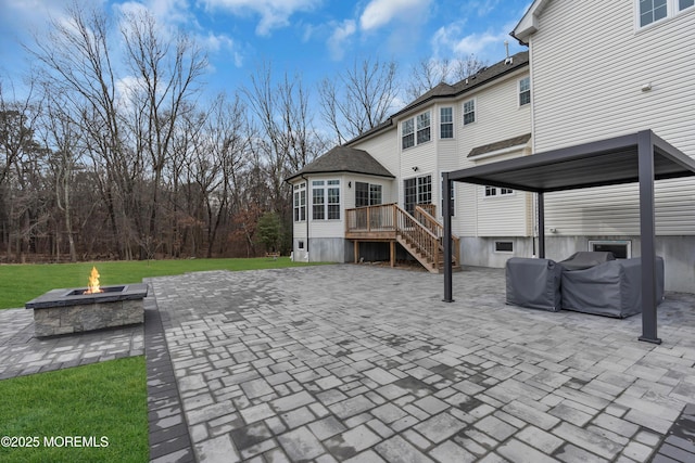 view of patio / terrace with a wooden deck and a fire pit