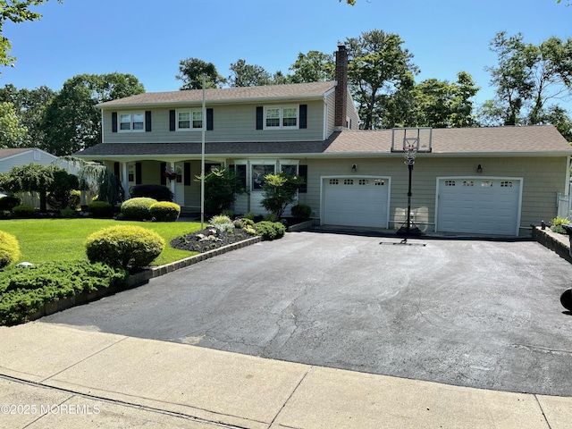 view of front property with a garage and a front yard