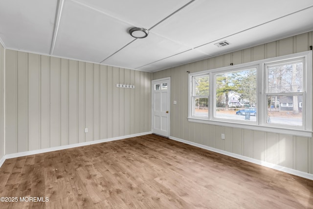 empty room with hardwood / wood-style flooring