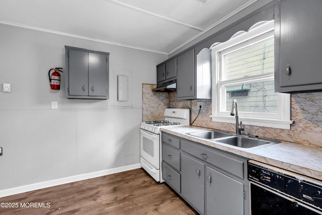 kitchen featuring gray cabinets, dishwasher, white gas range, and sink