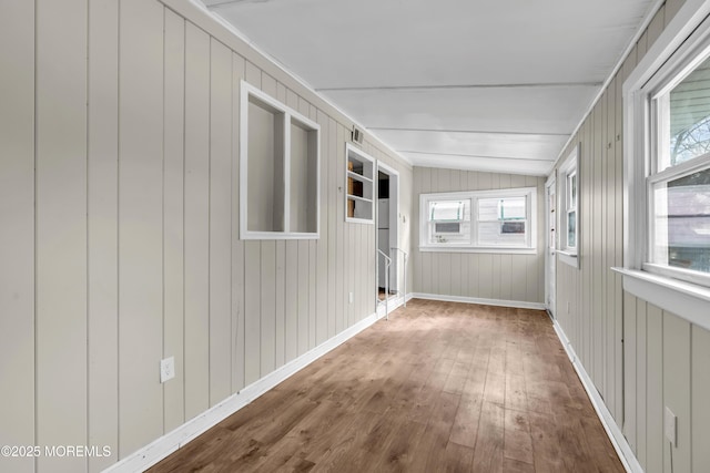 unfurnished sunroom with vaulted ceiling