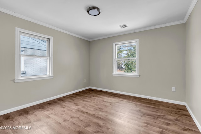 unfurnished room with hardwood / wood-style flooring and ornamental molding