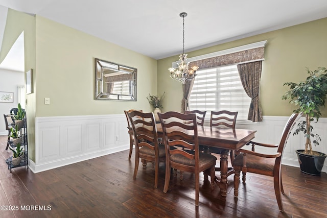 dining area with dark hardwood / wood-style flooring and a chandelier